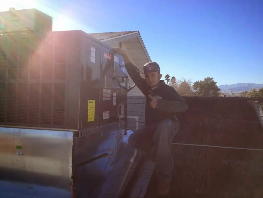 HVAC technician performing Boiler Repair on a rooftop unit in Maywood